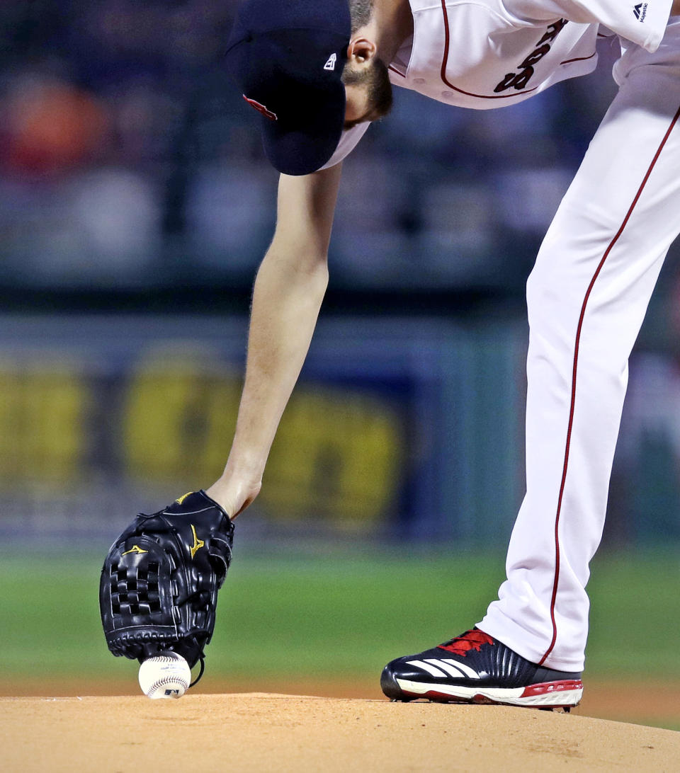 Boston Red Sox starting pitcher Chris Sale reaches down to the mound to pick up the baseball as he prepares for the the first inning of a baseball game against the Toronto Blue Jays at Fenway Park in Boston, Tuesday, Sept. 11, 2018. (AP Photo/Charles Krupa)