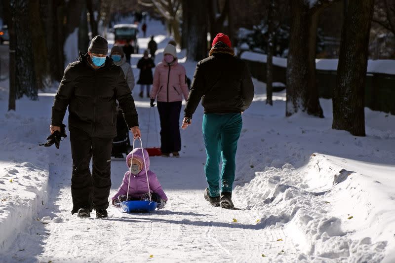 People play in the snow that fell during a Nor'easter storm in New York