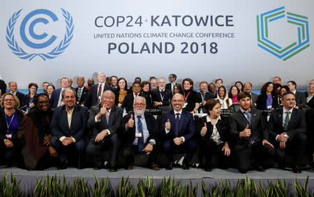 COP24 President Michal Kurtyka and Executive Secretary of the UN Framework Convention on Climate Change Patricia Espinosa pose with the heads of delegations after adopting the final agreement during a closing session of the COP24 U.N. Climate Change Conference 2018 in Katowice, Poland, December 15, 2018. REUTERS/Kacper Pempel