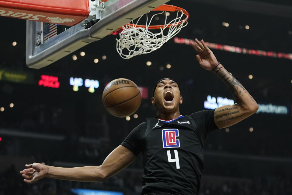 Los Angeles Clippers guard Brandon Boston Jr. (4) reacts after dunking the ball during the first half of an NBA basketball game against the Boston Celtics in Los Angeles, Wednesday, Dec. 8, 2021. (AP Photo/Ashley Landis)