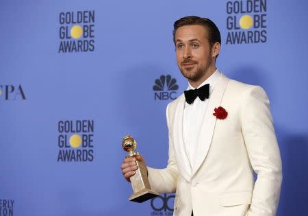 Ryan Gosling holds the award for Best Performance by an Actor in a Motion Picture - Musical or Comedy for his role in "La La Land" during the 74th Annual Golden Globe Awards in Beverly Hills, California, U.S., January 8, 2017. REUTERS/Mario Anzuoni