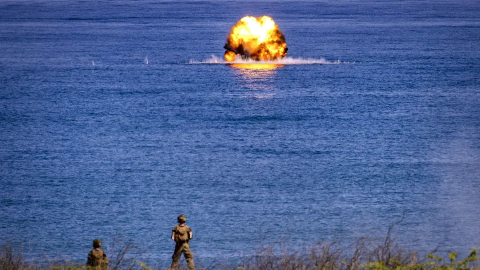 U.S. troops watch as a Javelin missile hits a target at sea during a counter-landing drill as part of U.S.-Philippines joint military exercises on May 6, 2024, in the north province of Ilocos Norte. (Ezra Acayan/Getty Images)