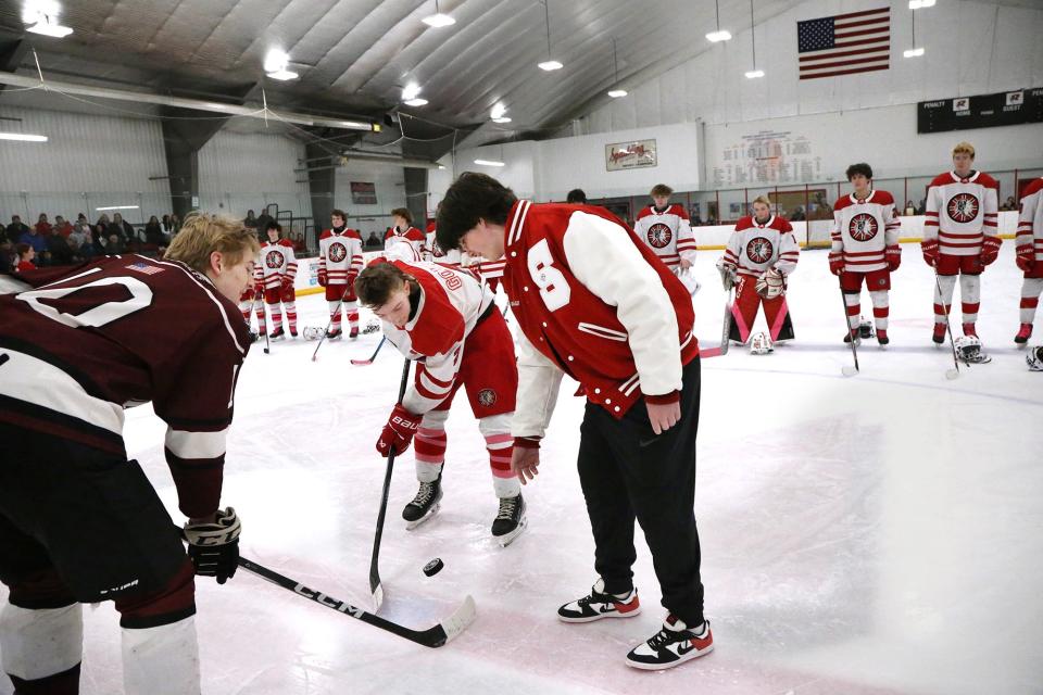 Spaulding High School junior Matt Gould drops a ceremonial puck prior to Wednesday's Division II boys hockey game against Portsmouth/Newmarket at Rochester Ice Arena.