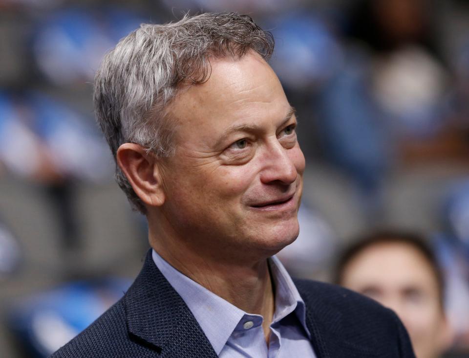 Actor Gary Sinise looks on before an NBA basketball game between the Washington Wizards and the Dallas Mavericks, Saturday, Dec. 12, 2015, in Dallas. (AP Photo/Jim Cowsert) ORG XMIT: TXJC1 [Via MerlinFTP Drop]