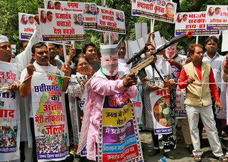 A supporter of India's main opposition Congress party holds a toy rifle as he takes part in what the party calls as a "Save Democracy" march to parliament in New Delhi, India, May 6, 2016. REUTERS/Altaf Hussain