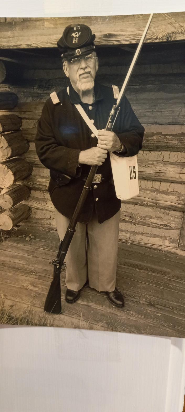 Local history researcher Dick Wells poses with his Union Army uniform and musket.