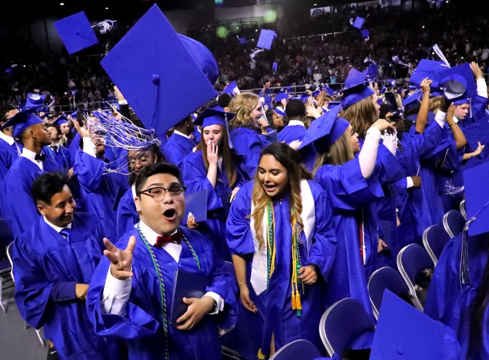 LaVergne graduate Miguel Blancas tosses his cap with other graduates at the end of the LaVergne High School graduation ceremony at MTSU's Murphy Center, on Sunday, May 19, 2019.