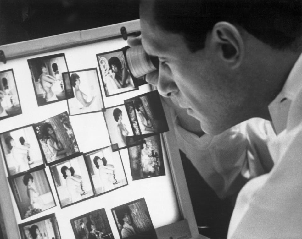 Hugh Hefner viewing&nbsp;photographs in his Chicago office. (Photo: Bettmann via Getty Images)