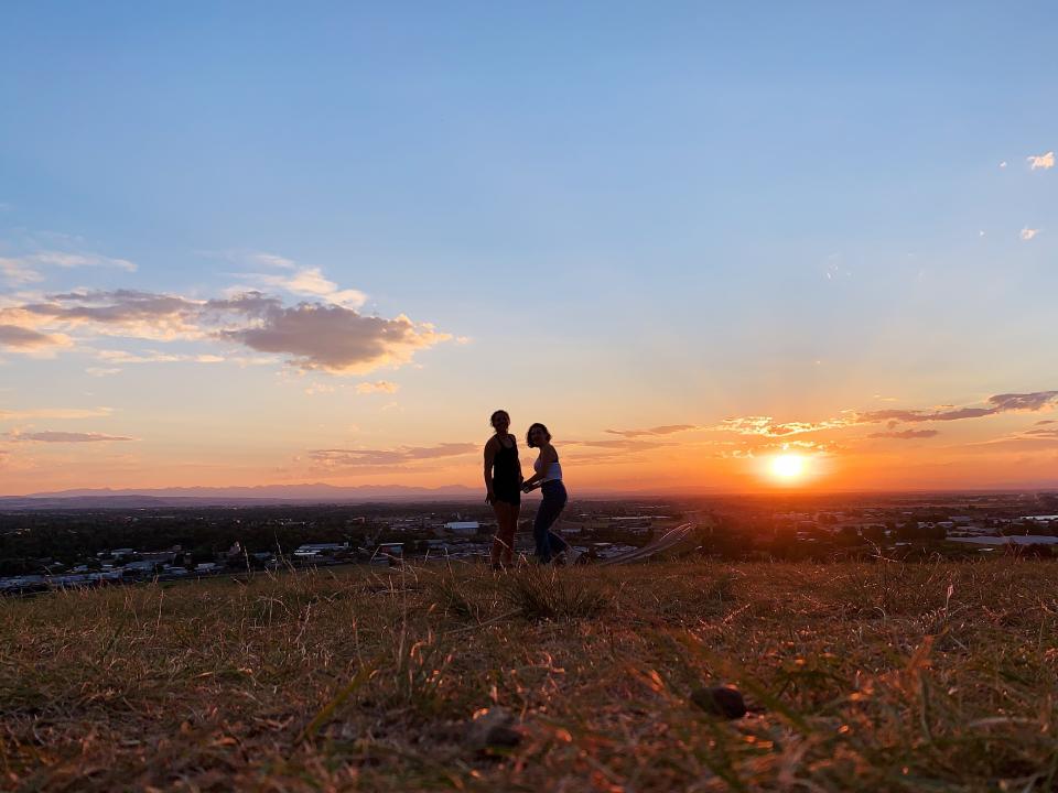 Two people's silhouettes against a sunset in Bozeman, Montana