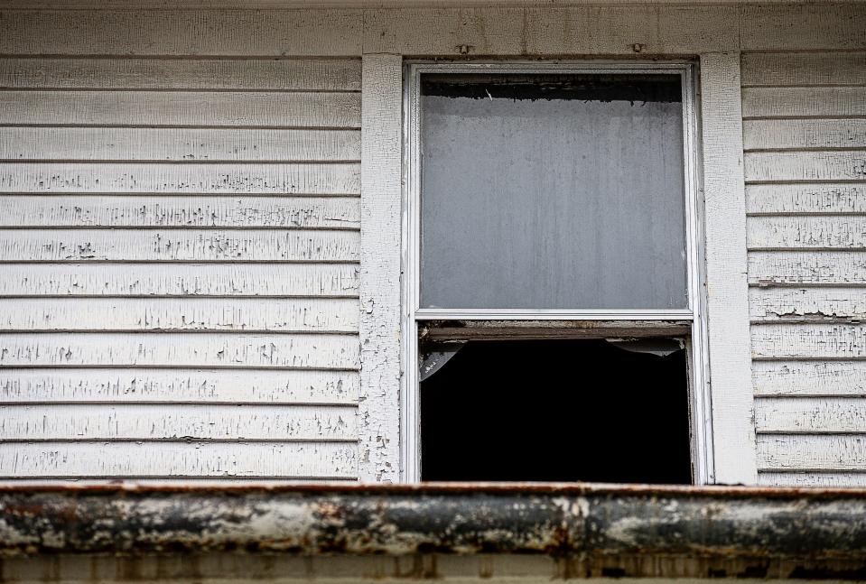 The exterior of this abandoned house on W. Kentucky Street in Louisville's California neighborhood shows the square, 'alligator skin' pattern distinctive of deteriorating lead paint. Aug. 1, 2023.