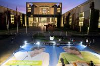 In this Thursday, Sept. 19, 2019 photo a giant poster showing German Chacellor Angela Merkel, right, and the chairwomen of the German Christian Democratic Party (CDU), Annegret Kramp-Karrenbauer, left, is displayed in front of the Chancellery in Berlin, Germany. The German government is scrambling to agree a package of measures for tackling global warming, as protesters prepare to stage rallies across the country demanding decisive action against climate change. (Kay Nietfeld/dpa via AP)