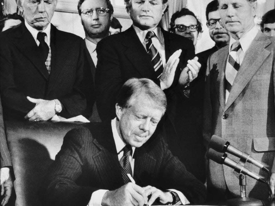 President Carter signs the airline deregulation bill at the White House