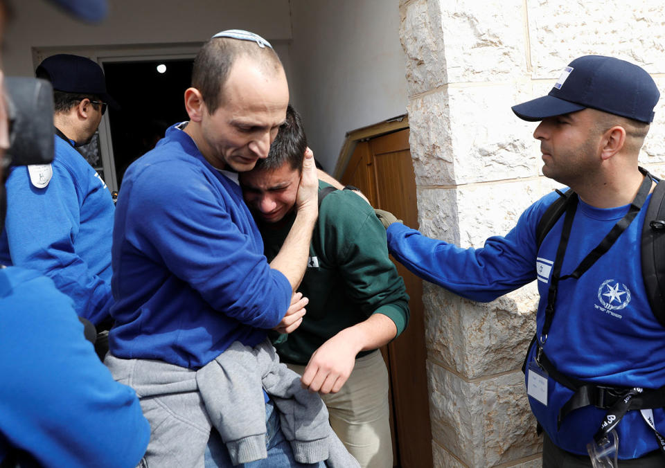 <p>Israeli police comfort a pro-settlement activist during an operation by Israeli forces to evict settlers from the West Bank settlement of Ofra, Tuesday, Feb. 28, 2017. Israeli forces began evacuating nine homes in the settlement following a Supreme Court decision that ruled they were built on private Palestinian land. REUTERS/Ronen Zvulun </p>