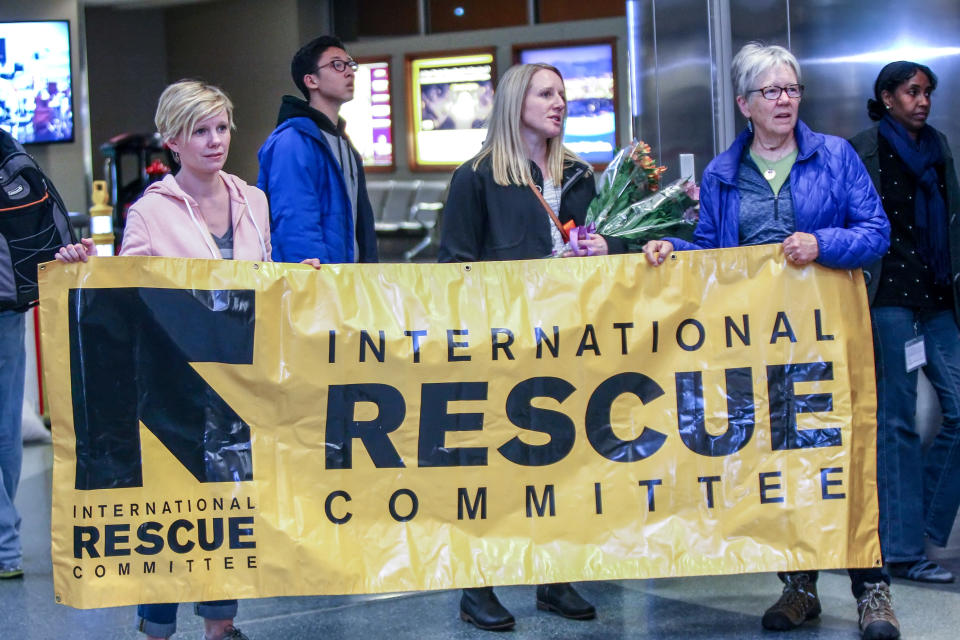 Members of the International Rescue Committee await the arrival of refugees from Somalia at the airport in Boise, Idaho, on March 10. (Photo: Brian Losness/Reuters)