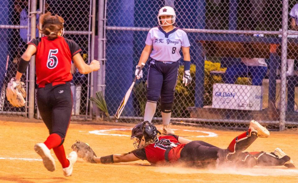 Dixie County Bears Peyton Hatcher (10) dives to make the game ending out in the fourth inning at home plate. P.K. Yonge Blue Wave hosted Dixie County Bears in softball at P.K. Yonge High School in Gainesville, FL on Tuesday, April 18, 2023. Dixie County defeated P.K. Yonge 17-0 after four innings.  [Doug Engle/Gainesville Sun]