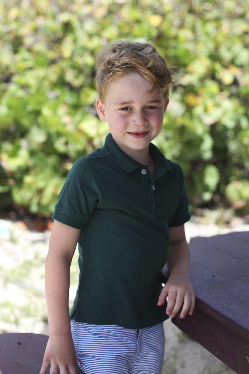 In this undated photo released by the Duke and Duchess of Cambridge on Sunday, July 21, 2019, Britain's Prince George poses for a photo taken by his mother, Kate, the Duchess of Cambridge, in the garden of their home at Kensington Palace, London. Prince George will celebrate his sixth birthday on Monday, July 22. (The Duchess of Cambridge via AP)