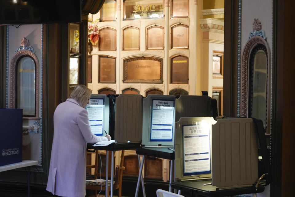 Paula Romanovsky votes in a booth at the Columbarium in San Francisco, Tuesday, March 5, 2024. The building dates to 1898 and contains over 8,500 niches. (AP Photo/Eric Risberg)