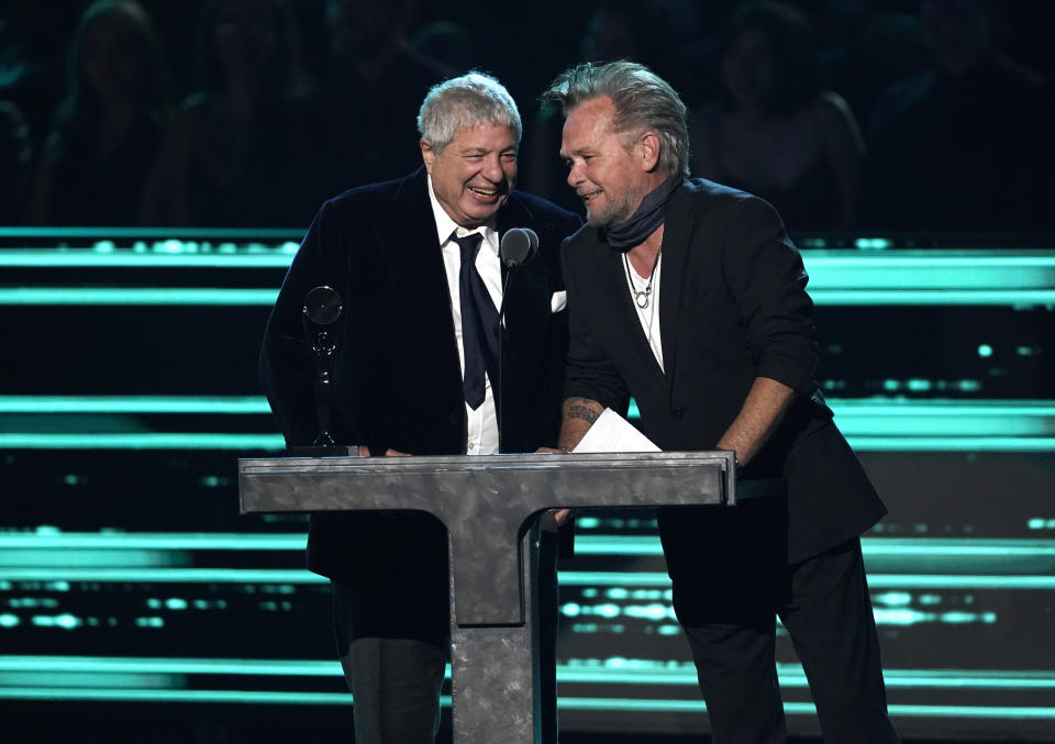 John Mellencamp, right, introduces inductee Allen Grubman during the Rock & Roll Hall of Fame Induction Ceremony on Saturday, Nov. 5, 2022, at the Microsoft Theater in Los Angeles. (AP Photo/Chris Pizzello)