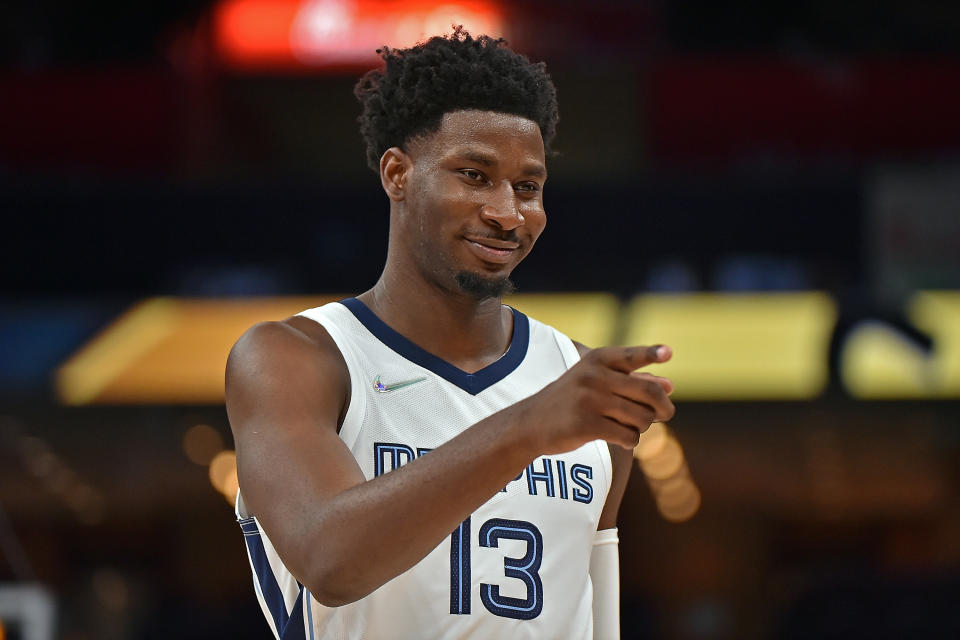 Jaren Jackson Jr. smiles and points to something out of frame.