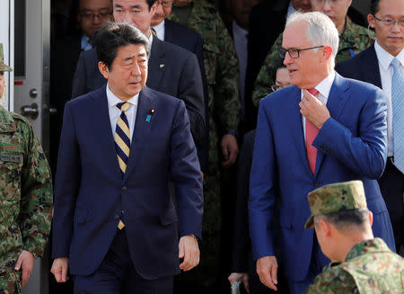 Australian Prime Minister Malcolm Turnbull (R) and Japanese Prime Minister Shinzo Abe arrive at Narashino exercise field in Funabashi, east of Tokyo, Japan January 18, 2018. REUTERS/Kim Kyung-Hoon