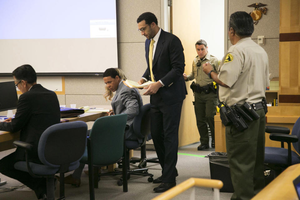 Former NFL football player Kellen Winslow Jr., standing center, takes his seat in the courtroom on the first day of his rape trial, Monday May 20, 2019, in Vista, Calif. (John Gibbins/The San Diego Union-Tribune via AP, Pool)