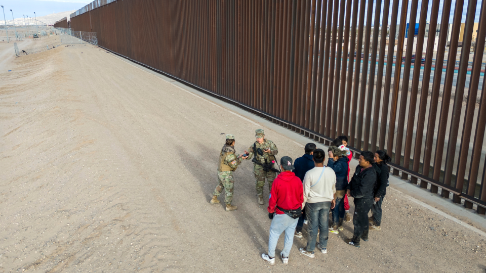 Troops stopping migrants near the U.S.-Mexico border wall (John Moore/Getty Images)