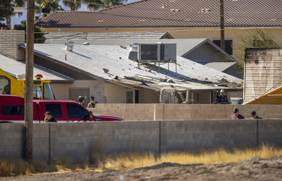 Firefighters and military personnel investigate an airplane crash near Nellis Air Force Base on Monday, May 24, 2021, in Las Vegas. (L.E. Baskow/Las Vegas Review-Journal via AP)