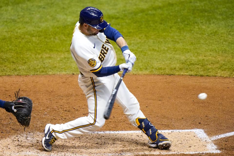 Milwaukee Brewers' Manny Pina hits a two-run home run during the sixth inning of a baseball game against the Minnesota Twins Tuesday, Aug. 11, 2020, in Milwaukee. (AP Photo/Morry Gash)