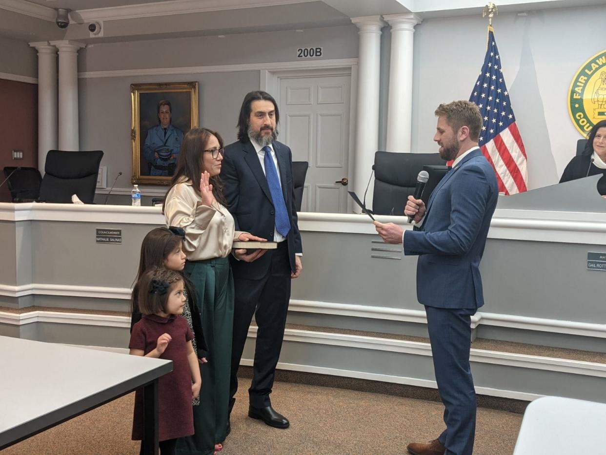 New Fair Lawn Councilwoman Nathalie Salinas stood with her family Tuesday while being sworn in by former mayor and current Borough Manager Kurt Peluso.