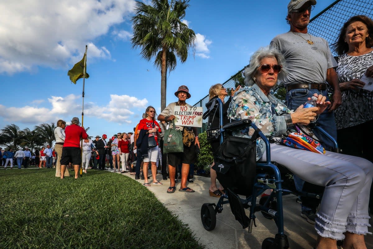 Supporters of former US President Donald Trump wait outside of Trump's President Day event at the Hilton Palm Beach Airport in West Palm Beach, Florida, on February 20, 2023 (AFP via Getty Images)