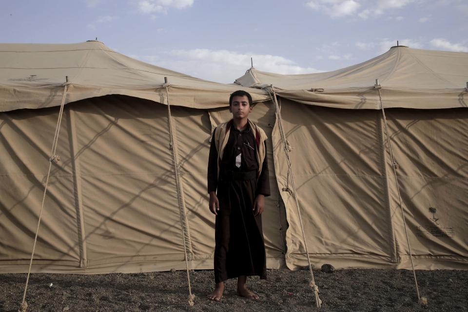 Sadek, a 14 year-old former child soldier, poses for a photograph at a camp for displaced persons where he took shelter with his family, in Marib, Yemen, in this July 27, 2018, photo. Houthi rebels plucked him from his home and promised he would only run supplies to adult fighters, but it wasn’t long before he found himself deployed to fight on the front lines of Yemen's civil war. (AP Photo/Nariman El-Mofty)