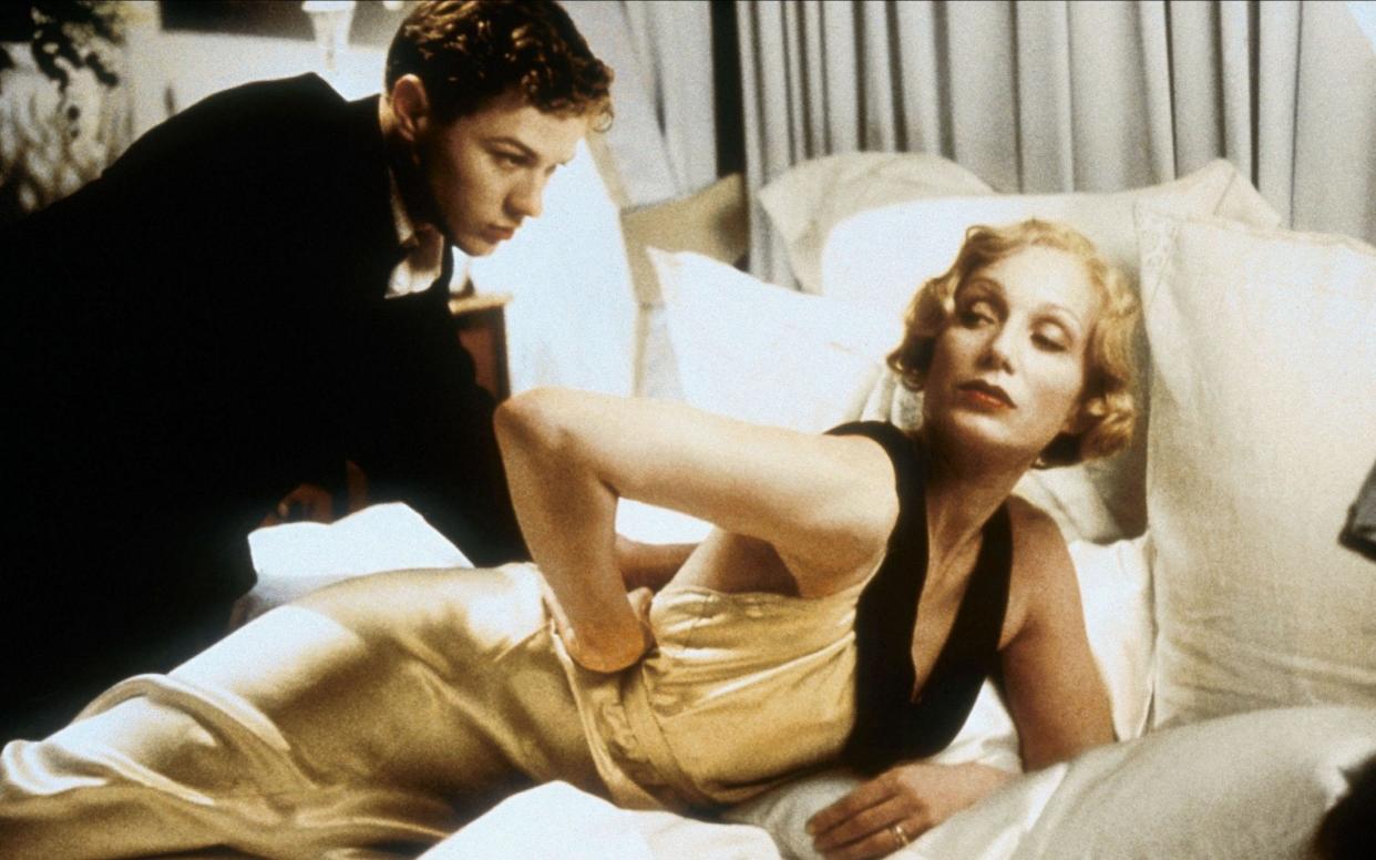 In Gosford Park, Lady Sylvia (Kristin Scott Thomas) has an assignation with valet Henry Denton (Ryan Phillippe) - www.alamy.com