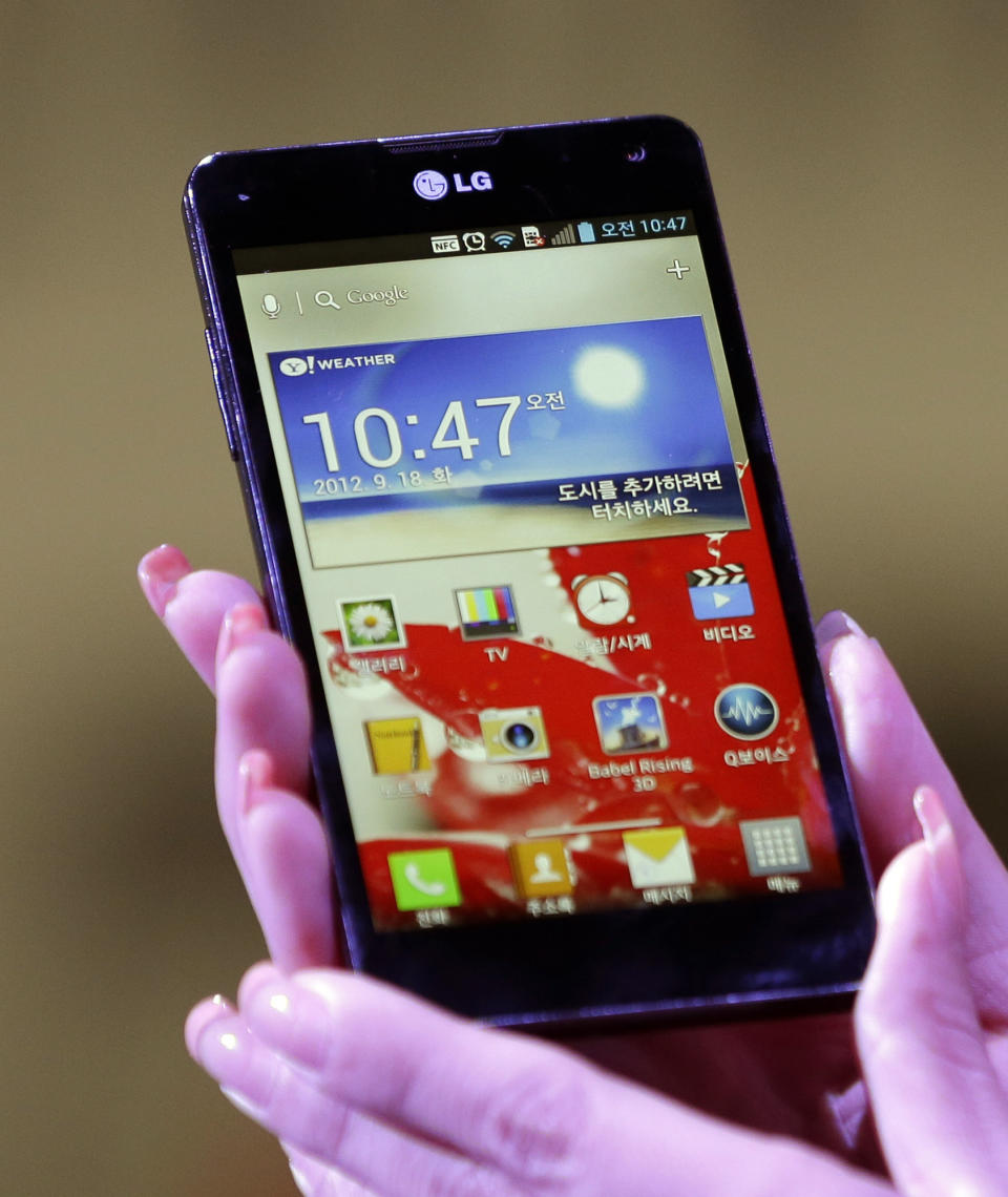 A model holds LG Electronics' new Optimus G smartphone during its unveiling ceremony in Seoul, South Korea, Tuesday, Sept. 18, 2012. LG Electronics will launch the Optimus G smartphone next week in South Korea, pinning hope on the new Android device to help revive its loss-making mobile business. (AP Photo/Lee Jin-man)