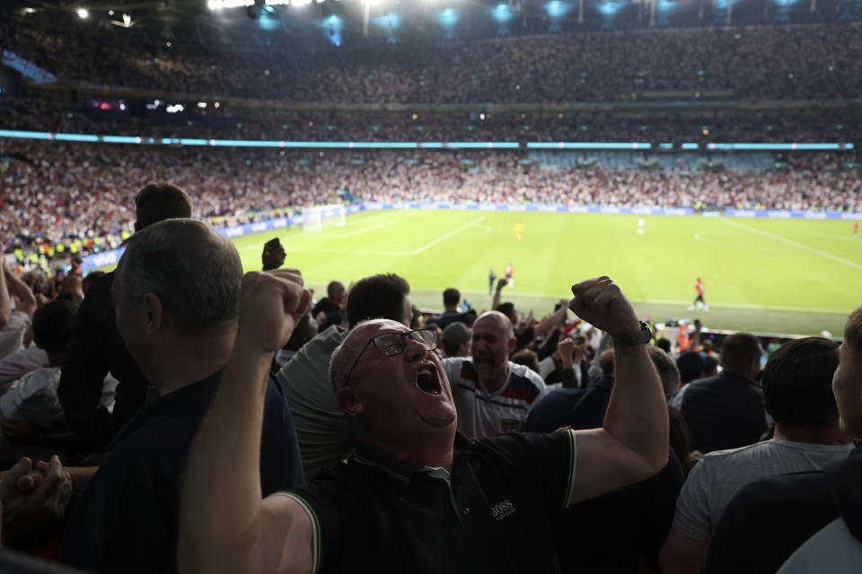 England supporters celebrate their team second goal during the Euro 2020 soccer championship semifinal match between England and Denmark at Wembley stadium in London, Wednesday, July 7, 2021. (Catherine Ivill/Pool Photo via AP)