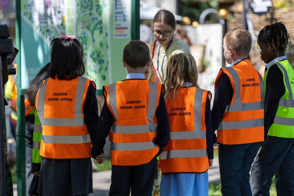 school children wearing orange vests