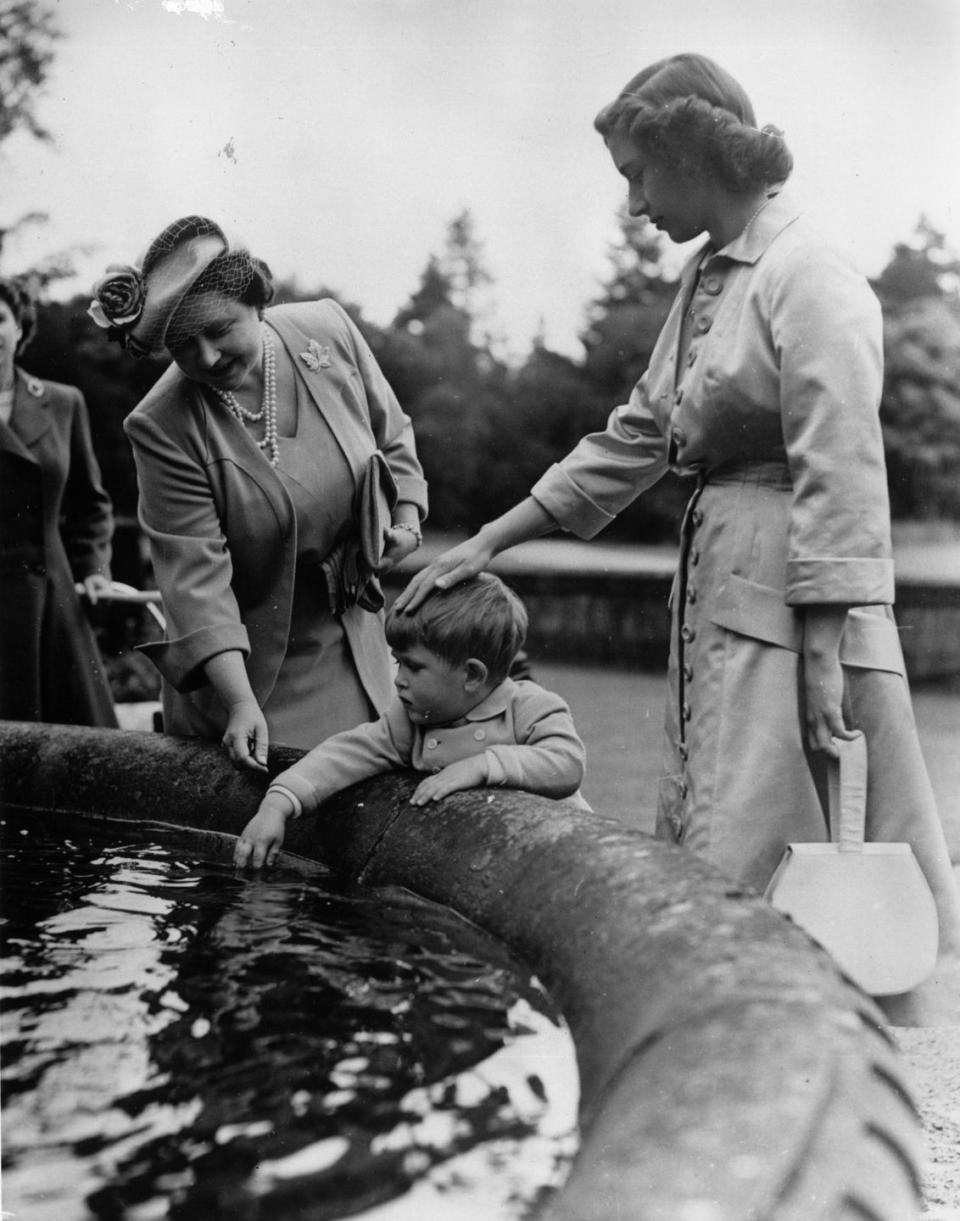 <p>During an annual trip to Balmoral Castle in Scotland, the royal family celebrates Princess Margaret's 21st birthday — but not before the Queen Mother and Margaret play with a 3-year-old Prince Charles in the fountain on the grounds. </p>