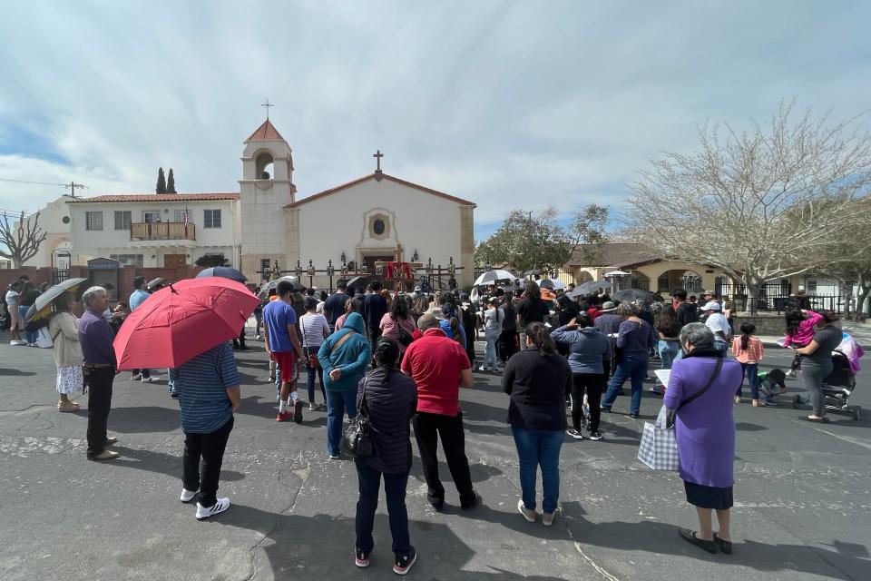 Hundreds of Good Friday worshipers observed the Stations of the Cross outside of St. Joan of Arc Catholic Church in Victorville.