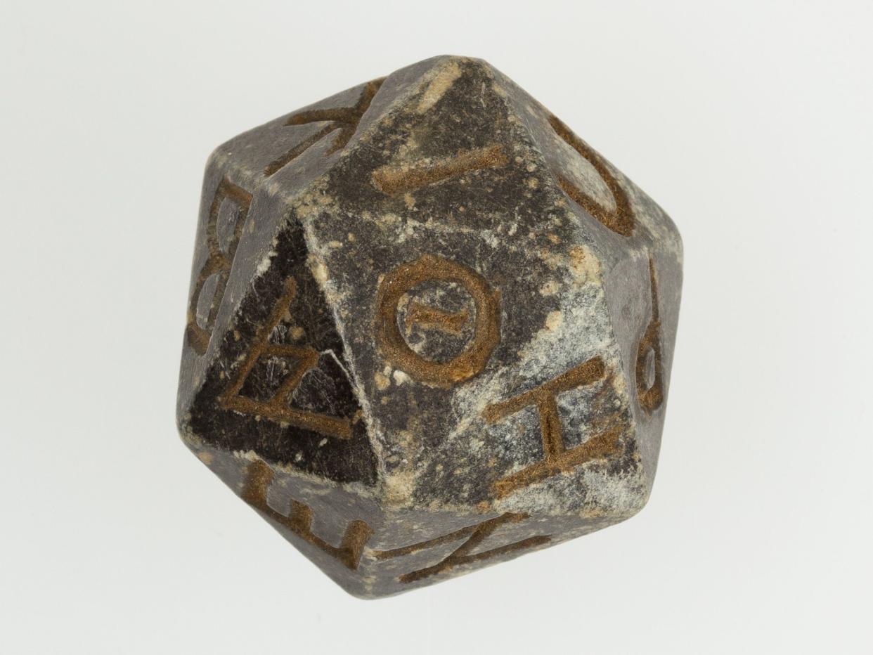 Twenty-sided die (icosahedron) with faces inscribed with Greek letters