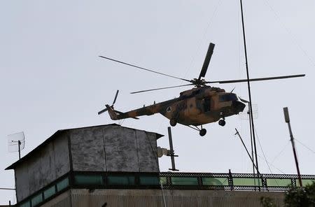 Afghan Air forces helicopter flies over the site of a suicide attack followed by a clash between Afghan forces and insurgents during an attack on the Iraqi embassy in Kabul, Afghanistan July 31, 2017.REUTERS/Mohammad Ismail