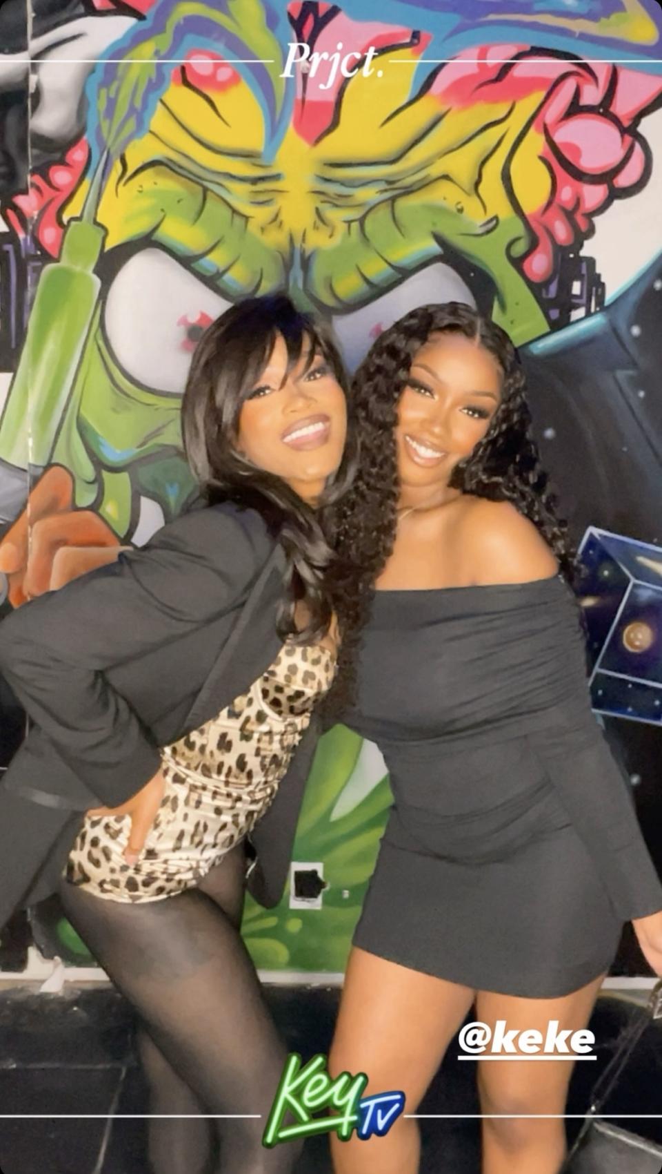 Keke Palmer and Kenya Alexis standing in front of a step and repeat