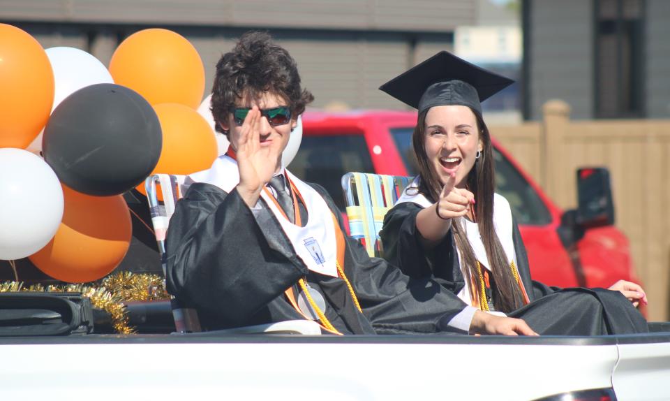 Cheboygan's Luke Karsten and Alyssa Bur wave during Friday's senior parade.