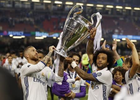 Britain Soccer Football - Juventus v Real Madrid - UEFA Champions League Final - The National Stadium of Wales, Cardiff - June 3, 2017 Real Madrid's Sergio Ramos and Marcelo celebrate with the trophy after winning the UEFA Champions League Final Reuters / John Sibley Livepic