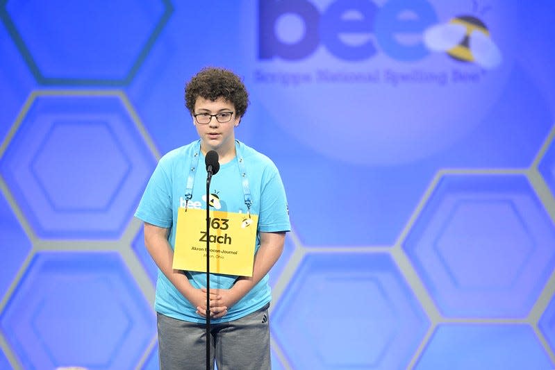 Zachary Yeager of Doylestown, representing The Akron Beacon Journal in the Scripps National Spelling Bee, works with the pronouncer during Tuesday's early rounds of competition. Yeager was successful in his first three rounds of the bee, and will compete Wednesday in Oxon Hill, Maryland.