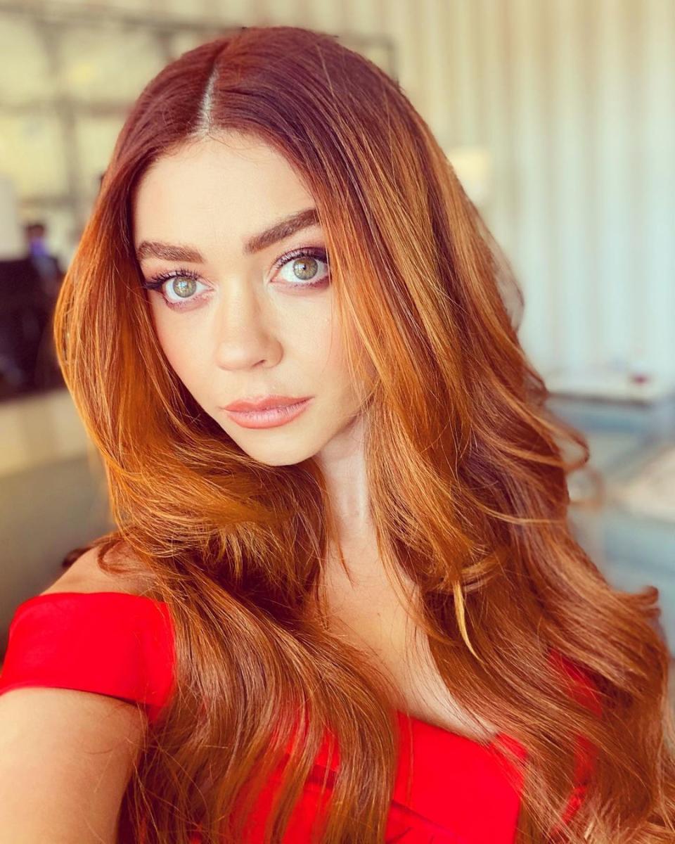 Sarah Hyland wearing a red gown at The Beverly Hilton at the 2021 Golden Globe Awards