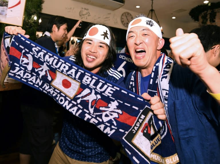 Japanese football fans celebrate taking revenge over Colombia, who thrashed Japan 4-1 at the 2014 World Cup in Brazil