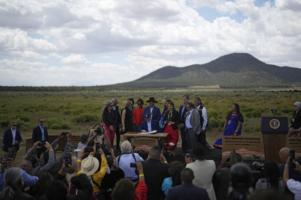 President Joe Biden signs a proclamation designating the Baaj Nwaavjo I'Tah Kukveni National Monument at the Red Butte Airfield Tuesday, Aug. 8, 2023, in Tusayan, Ariz. (AP Photo/John Locher)