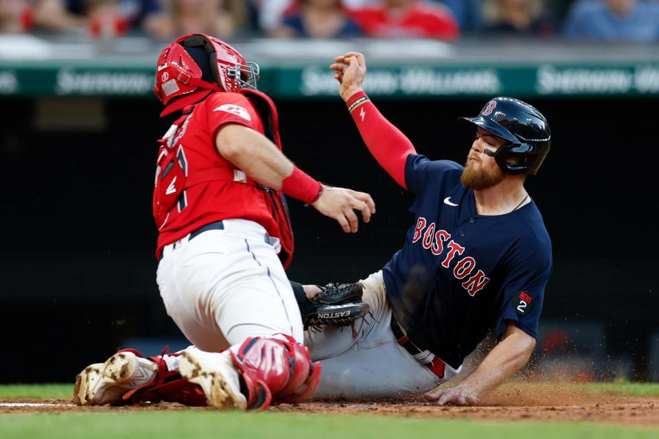 Boston Red Sox baserunner Christian Arroyo, right, is tagged out by Guardians catcher Austin Hedges on a throw by rookie right fielder Oscar Gonzalez during Friday night's game. The Red Sox won 6-3 [Ron Schwane/Associated Press]