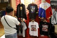 A fan looks at a jacket of boxer Manny Pacquiao of the Philippines displayed for sale inside a store in metro Manila April 24, 2015. REUTERS/Romeo Ranoco