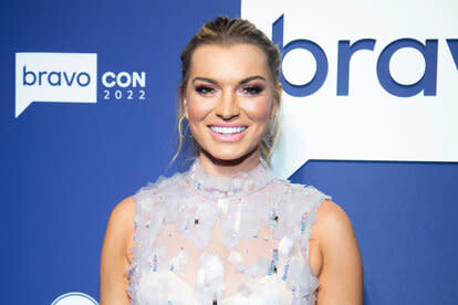 Lindsay smiling in a gown in front of the BravoCon 2022 step and repeat.