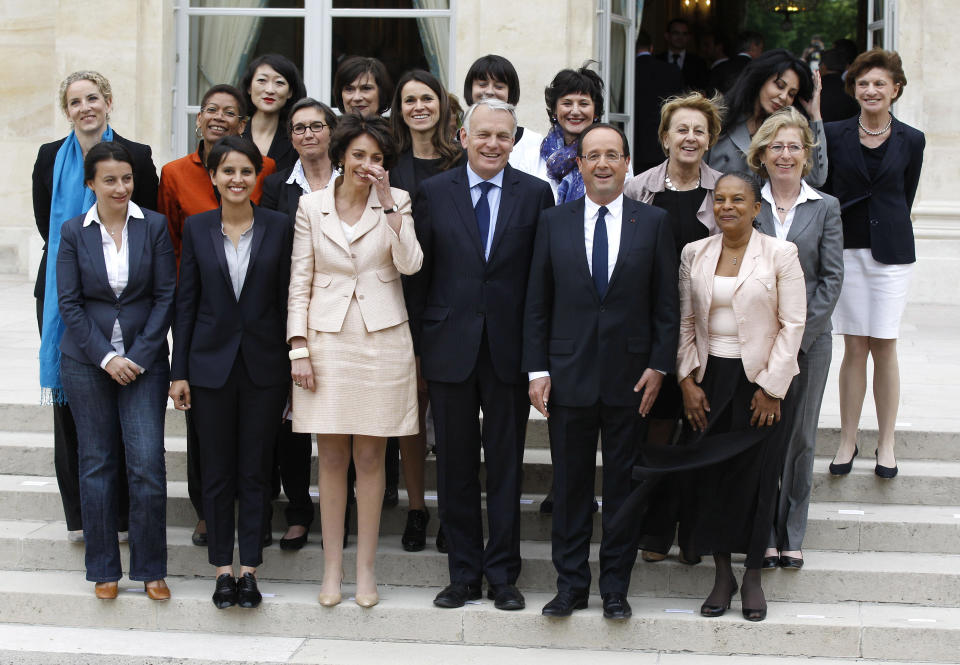 CORRECTS NAME OF PRIME MINISTER TO JEAN-MARC AYRAULT -- FILE -- In this May, 17, 2012 file photo, French President Francois Hollande, second right, and Prime Minister Jean-Marc Ayrault, center, pose with women of the cabinet after the first weekly cabinet meeting, at the Elysee Palace in Paris. Prime Minister Jean-Marc Ayrault has asked the French equality ministry to set up a series of 45 minute workshops, where politicians are given examples of sexism in daily life and with the aid of slide-shows taught how to avoid sexist stereotypes in political communication. First row from the left: Housing Minister Cecile Duflot, Women's Rights minister Najat Vallaud-Belkacem, Social Affairs Minister Marisol Touraine, Justice Minister Christiane Taubira, right. second row from the left: Deputy Justice Minister delphine Batho, Deputy Education Minister George Pau-Langevin, Sports Minister Valerie Fourneyron, Culture Minister Aurelie Filippeti, Family Affairs Dominique Bertinotti, State Labor Minister Marylise Lebranchu, Environment Minister Nicole Bricq. Top from the left: Minister for Small Business and the Digital Economy Fleur Pellerin, Deputy minister in charge of French citizen living abroad and French speaking countries Yamina Benguigui , second right, and Elderly People Minister Michele Delaunay. (AP Photo/Michel Euler, File)